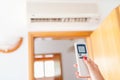 Close up on hand adjusting temperature of home air conditioner Royalty Free Stock Photo