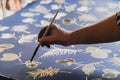 The close-up hand of  artist is painted on the fabric Royalty Free Stock Photo