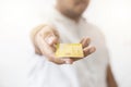 Close-up hand of Asian man holding yellow gold credit card in his hand. isolated on white background. Concept of finance, trading Royalty Free Stock Photo