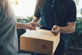 Close up of hand asian man using smartphone pressing screen to sign for delivery from the courier at home