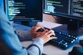 close up hand of Asian prompt engineer develop coding app with software data sitting in front of computer monitor at office