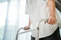 Close up hand of Asian Senior elderly disabled man patient walk slowly with walker at nursing home. Older handicapped male have