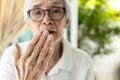 Close up of hand,asian senior woman checking breath,old elderly doing a bad breath test,foul mouth,strong unpleasant,smelling Royalty Free Stock Photo