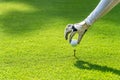 Close up hand asian sporty woman putting golf ball on tee with club in golf course on evening on time for healthy sport. Banner an Royalty Free Stock Photo