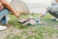 Close-up. Hand of asian woman grill marshmallow on bonfire in camping, picnic in campfire. Camping in vacation concept summer time