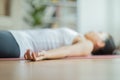 Close up hand of Asian woman practice yoga Dead Body or Savasana pose with meditation smile at home Feeling so comfortable and