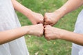 Close up of hand asian woman senior giving fist bump to hands young women at outdoor