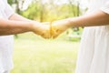 Close up of hand asian woman senior giving fist bump to hands young women at outdoor,Positive attitude and open mind