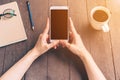 Close up hand asian woman using phone in coffee shop and sunlight with vintage filter. Royalty Free Stock Photo