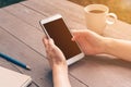 Close up hand asian woman using phone in coffee shop and sunlight with vintage filter. Royalty Free Stock Photo