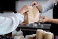 Close up hand. Asian young man or bartender serving customer at coffee shop. making coffee in coffee cafe. Concept sale paper bag Royalty Free Stock Photo