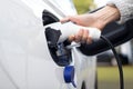 Close Up Of Hand Attaching Power Cable To Environmentally Friendly Zero Emission Electric Car Royalty Free Stock Photo