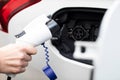 Close Up Of Hand Attaching Power Cable To Environmentally Friendly Zero Emission Electric Car Royalty Free Stock Photo