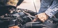 Close-up hand of auto mechanic using wrench to repair a car engine.