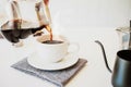 Close up. Hand of a barista poured water dripping hot coffee into the cup with smoke and equipment, tool brewing at kitchen home Royalty Free Stock Photo