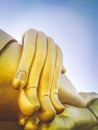 Close up hand of big Buddha statue with blue sky at Wat Tha Muang Thailand. The most specifically iconic Golden Buddha statues Royalty Free Stock Photo