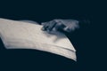 A hand of a blind person reading a braille system book