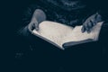 A hand of a blind person reading a braille system book