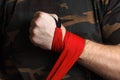 Close-up of hand boxer pulls wrist wraps before the fight