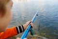 close-up of the hand of a boy who holds a fishing rod and fishes Royalty Free Stock Photo