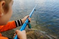 close-up of the hand of a boy who holds a fishing rod and fishes Royalty Free Stock Photo