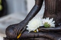 Close up Hand of The Buddha statue dark color with flower in temple Royalty Free Stock Photo