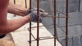 Hands Builder In Dirty Gloves Tied Steel Wire On Rebar Tool On Construction Site