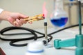 Close up of hand with burning needle in lab tongs Royalty Free Stock Photo