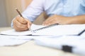 Close up hand business man are sitting using pen writing record Royalty Free Stock Photo