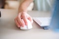 Close up hand man using mouse and computer at home with morning light Royalty Free Stock Photo