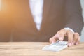 Close up hand of businessman holding money dollar bills on wooden table. Using as concept of corruption Royalty Free Stock Photo