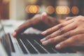 Close up hand of businessman typing on a laptop keyboard in wor Royalty Free Stock Photo