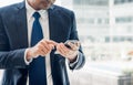 Close up hand of businessman using mobile phone near office wind Royalty Free Stock Photo