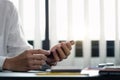 close up hand of businessman using mobile phone at office building, online business concept. Royalty Free Stock Photo