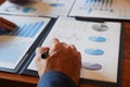 Close-up hand of businessman writing, reviewing document in office