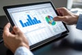 Close-up hand of Businessperson uses a tablet for analysis of business data