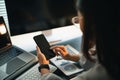 Close up Hand Businesswoman using smartphone after working with laptop, woman using mobile phone search or social media or