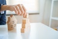 Close-up hand of businesswomen a pyramid with empty wooden cubes, concept of design house