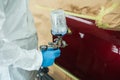 Close-up of the hand of a car painter with spray gun in his hand. Royalty Free Stock Photo