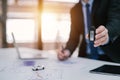 Close-up hand of car salesman handing over your new car keys at a desk with a laptop. dealership and online sales concept Royalty Free Stock Photo