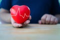 Close up of hand with cardiogram on red heart. Concept for charity Royalty Free Stock Photo