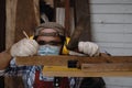 Close up hand of carpenter using square angle ruler tool and pencil to mark position for cut in the carpentry workshop Royalty Free Stock Photo