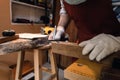 Close up hand of carpenter using square angle ruler tool and pencil to mark position on wood for cut in the workshop Royalty Free Stock Photo