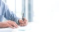 Close up of hand Caucasian young businessman signing a contract. About the financial business in the office. Panoramic web banner Royalty Free Stock Photo