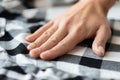 Close up of hand with checkered clothing item