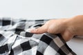 Close up of hand with checkered clothing item