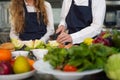 Close up hand Chef the group children cut vegetables in class kitchen room.