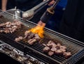 Close up hand of chef using flame torch burn on Japanese wagyu beef