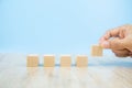 Close-up hand choose cube shape wooden block toy without graphics for Business design Royalty Free Stock Photo