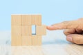Close-up hand choose a cube shape wooden block toy stacked without graphics for Business design concept Royalty Free Stock Photo